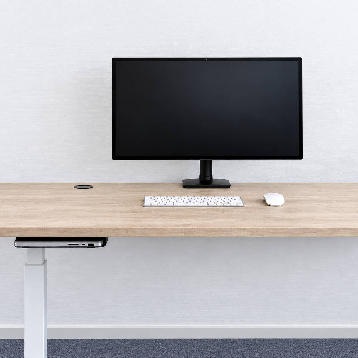 Clean desk setup with a MacBook Pro hidden under the desk on a SlideUnder Crossbar mount - DockedByDesign